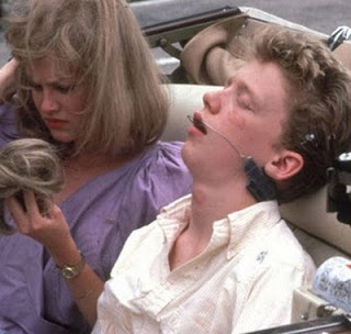 Two siblings laughing while reminiscing in a cozy living room