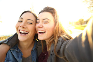 Sunlight breaking through clouds over a city skyline