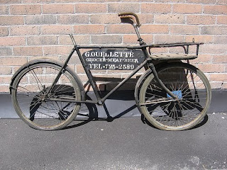 Sunlit cracked sidewalk and weeds along Macintosh Road