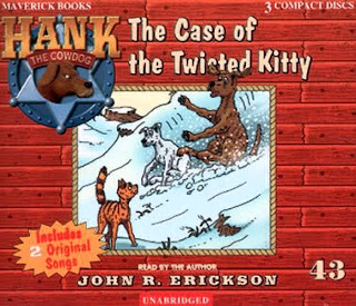 Two domestic cats sitting together looking alert