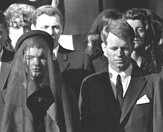 Grainy black-and-white image from JFK assassination documentary